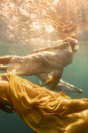 Underwater picture with four women are swimming wearing Mulberry silk dresses.