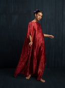Flowing red eco-dyed mulberry silk kaftan in motion, handcrafted botanical-dyed maxi dress with relaxed fit, sustainable luxury fashion for resort, evening, and special occasions