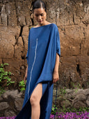 Indigo blue mulberry silk kaftan with white vertical line detail and thigh-high slit, handcrafted botanical-dyed maxi dress for sustainable luxury resort, evening, and coastal fashion