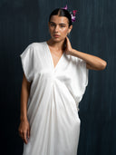 Close-up of ivory white mulberry silk kaftan with deep V-neck and cap sleeves, handcrafted luxury maxi dress in sustainable botanical dye, elegant bridal and resort wear