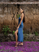 Side view of long hair woman wearing Rimmba's Lily silk midi dress indigo. Hancrafted Botanical-dyed sustainable luxury fashion for wedding and resort wear.