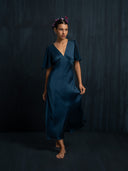 A woman wearing Rimmba's Olivia vintage silk mullberry dress v-neckline and silkchiffon sleeves. Hancrafted botanical-dyed sustainable luxury fashion for formal and resort wear.