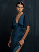 Close up view of woman wearing Rimmba's Olivia vintage silk dress indigo. Hancrafted botanical-dyed sustainable luxury fashion for bridal and resort wear.