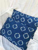 The Rimmba | Sustainable Clothing Pua Silk Pillow Case 2x - Set features two blue hypoallergenic cases with a white geometric tie-dye pattern, displayed on a textured white fabric background.