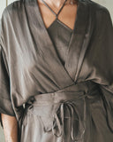Close-up of woman wearing a Mulberry silk top Mud-dye with a matching color robe. Hancrafted sustainable cloths for daily, bridal, and resort wear.