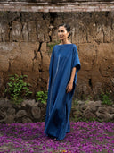 Indigo blue mulberry silk kaftan with white vertical line accent, handcrafted botanical-dyed maxi dress with flowing drape, sustainable luxury fashion for resort, evening, and special occasions