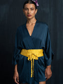 Close-up of mulberry silk kimono indigo and yellow silk belt. Luxury fashion for bridal, daily, and resort wear.