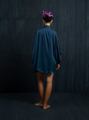 Back view of mulberry silk kimono indigo without belt against a dark background.